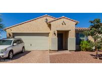 Single-story home with a two-car garage and landscaped yard at 17986 W Fulton St, Goodyear, AZ 85338