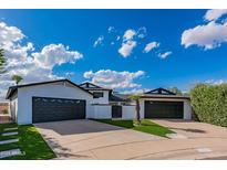 Two-car garage with modern design features and landscaping at 6514 N 85Th Pl, Scottsdale, AZ 85250