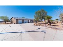 House exterior showcasing a two-car garage and desert landscaping at 3718 S 379Th Ave, Tonopah, AZ 85354