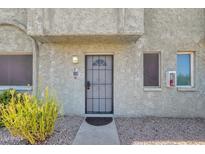 Exterior view of condo building entrance with security door at 1500 W Rio Salado Pkwy # 122, Mesa, AZ 85201