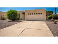 Single-story home with attached garage and landscaping at 9327 E Sun Lakes Blvd, Sun Lakes, AZ 85248