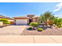 Single-story home with a paved driveway and desert landscaping at 31207 N 124Th Dr, Peoria, AZ 85383