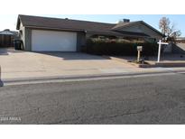 House exterior showcasing a well-maintained front yard and driveway at 12236 N 47Th Dr, Glendale, AZ 85304