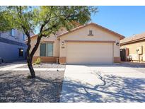 House exterior with a two-car garage and desert landscaping at 3998 N 294Th Ln, Buckeye, AZ 85396