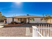 White brick house with a landscaped front yard, walkway, and decorative fountain at 721 W 3Rd Pl, Mesa, AZ 85201