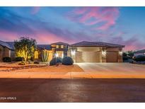Stunning curb appeal with desert landscaping at dusk at 18364 N Diamond Dr, Surprise, AZ 85374