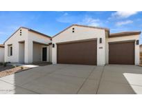 Two-car garage and front elevation of a modern home with desert landscaping at 37735 W Padilla St, Maricopa, AZ 85138