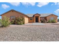 Single story home with landscaped yard and large driveway at 9023 S Dean Rd, Buckeye, AZ 85326