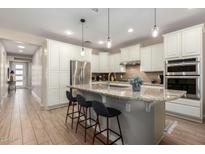 Modern kitchen with granite countertops, stainless steel appliances, and an island at 12794 W Burnside Trl, Peoria, AZ 85383