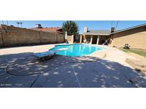 Inviting backyard pool with diving board and patio at 5121 W Saint Moritz Ln, Glendale, AZ 85306