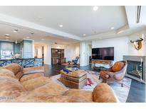 Spacious living room with leather furniture and fireplace at 2211 E Camelback Rd # 505, Phoenix, AZ 85016