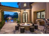 Backyard patio with fire pit and pool view at 9848 E Parkside Ln, Scottsdale, AZ 85255