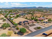 Single-story home with solar panels, large lot, and desert landscaping; mountain views at 1542 W Maddock Rd, Phoenix, AZ 85086