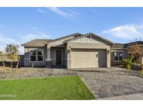 Single-story home with a two-car garage and landscaped front yard at 19366 W San Juan Ave, Litchfield Park, AZ 85340