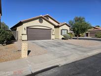 One-story house with a two-car garage and desert landscaping at 19762 N Locke Ct, Maricopa, AZ 85138