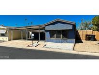 Mobile home with carport and landscaped yard at 10951 N 91St Ave # 17, Peoria, AZ 85345