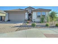 House exterior showcasing a two-car garage and well-maintained landscaping at 1957 W Fawn Way, San Tan Valley, AZ 85144