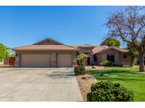 Two-story house with three-car garage and landscaped lawn at 10913 N 153Rd Ln, Surprise, AZ 85379