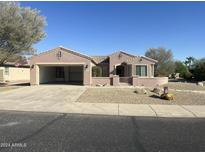 One-story home with two-car garage and desert landscaping at 20117 N Portico Way, Surprise, AZ 85387