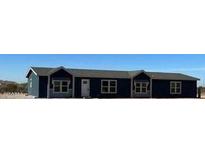 Blue manufactured home with three sections and a small front yard at 11896 N Canyon Ave, Maricopa, AZ 85139