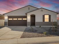 Single-story home with brown garage door and landscaped front yard at 37517 W San Clemente St, Maricopa, AZ 85138