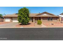 Brick ranch house with two-car garage at 6034 E Hillview St, Mesa, AZ 85205