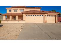 Two-story house with three-car garage and desert landscaping at 10520 W Patrick Ln, Peoria, AZ 85383