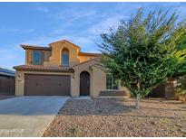 Two-story house with brown accents and a landscaped yard at 2199 E Gillcrest Rd, Gilbert, AZ 85298