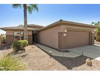 Single story home with attached garage and desert landscaping at 19051 N Aztec Point Dr, Surprise, AZ 85387