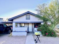 Light gray single story home with a small front yard at 205 N Cameron Ave, Casa Grande, AZ 85122