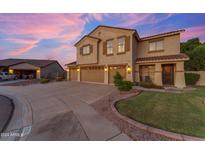 Two-story house with three-car garage, landscaping, and a large driveway at 32311 N Cat Hills Ave, San Tan Valley, AZ 85144