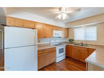 Cozy kitchen with light wood cabinets and modern appliances at 2308 N Gayridge Rd, Mesa, AZ 85215