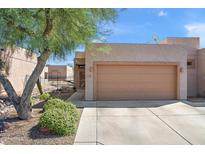 Tan stucco home with a two-car garage at 913 S Apache Dream Way, Apache Junction, AZ 85120