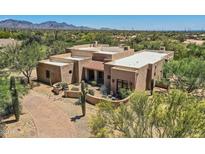 Aerial view of a large, stucco home with desert landscaping at 26615 N 71St Pl, Scottsdale, AZ 85266