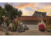 Spanish style home with a two-car garage and lush landscaping at 8870 E Greenview Dr, Gold Canyon, AZ 85118