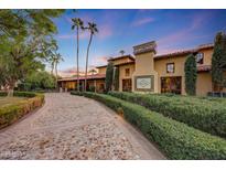 Tuscan-style home with a stone driveway and manicured landscaping at 6107 E Paradise Dr, Scottsdale, AZ 85254