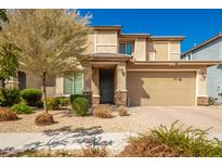 Two story home with tan exterior and two car garage at 2440 E Saint Catherine Ave, Phoenix, AZ 85042