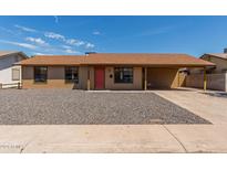 Ranch style home with a carport and rock landscaping at 8508 W Clarendon W Ave, Phoenix, AZ 85037