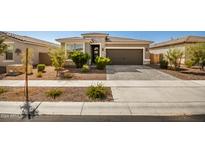 Modern single story home with two car garage and well manicured landscaping at 17657 W Buckhorn Trl, Surprise, AZ 85387