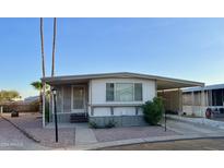 Mobile home with covered parking and desert landscaping at 11411 N 91St Ave # 217, Peoria, AZ 85345