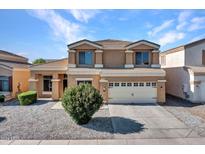 Two-story house with a two-car garage and landscaped yard at 8312 W Pioneer St, Tolleson, AZ 85353