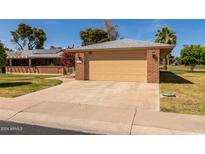 Attached garage with an automatic door opener and ample space at 10962 W Kelso Dr, Sun City, AZ 85351
