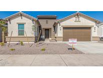 New construction home exterior with two-car garage at 21048 E Arroyo Verde Dr, Queen Creek, AZ 85142