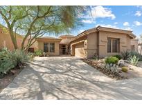 Front view of a two-story house with a large driveway at 7473 E Soaring Eagle Way, Scottsdale, AZ 85266