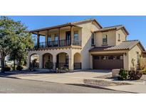 Two-story home with balcony, two-car garage, and landscaped yard at 15409 W Corrine Dr, Surprise, AZ 85379