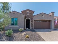 Single-story home with brick facade and two-car garage at 16917 W Sheridan St, Goodyear, AZ 85395