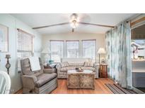 Living room with wicker coffee table and comfy armchairs at 312 S Emerald Dr, Apache Junction, AZ 85119