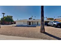 Ranch style home with a spacious front yard and mature palm trees at 1701 W Highland Ave, Phoenix, AZ 85015