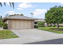 Single-car garage with driveway and landscaping at 9701 W Oak Ridge Dr, Sun City, AZ 85351