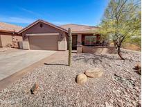 Single-story home with two-car garage and desert landscaping at 563 S 230Th Ave, Buckeye, AZ 85326